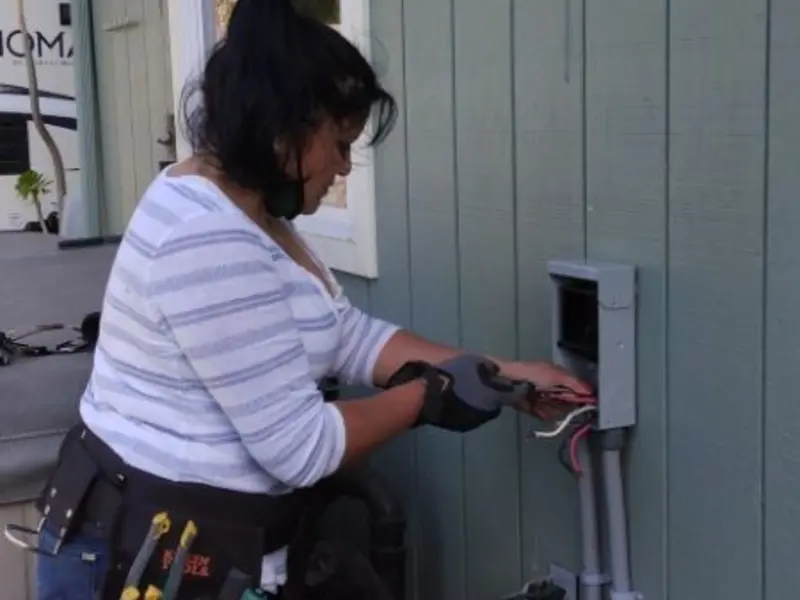 Licensed electrician wiring an exterior subpanel in China